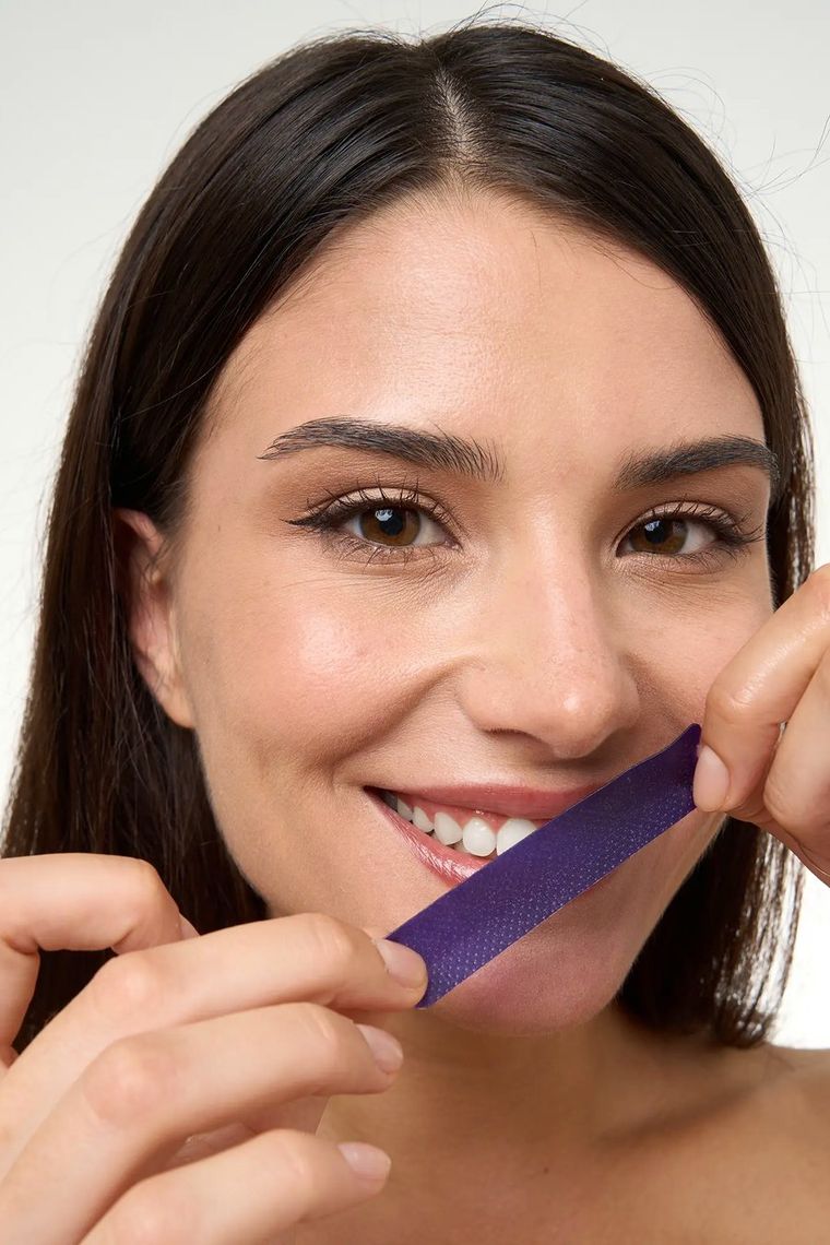 Peeling a whitening strip from its backing